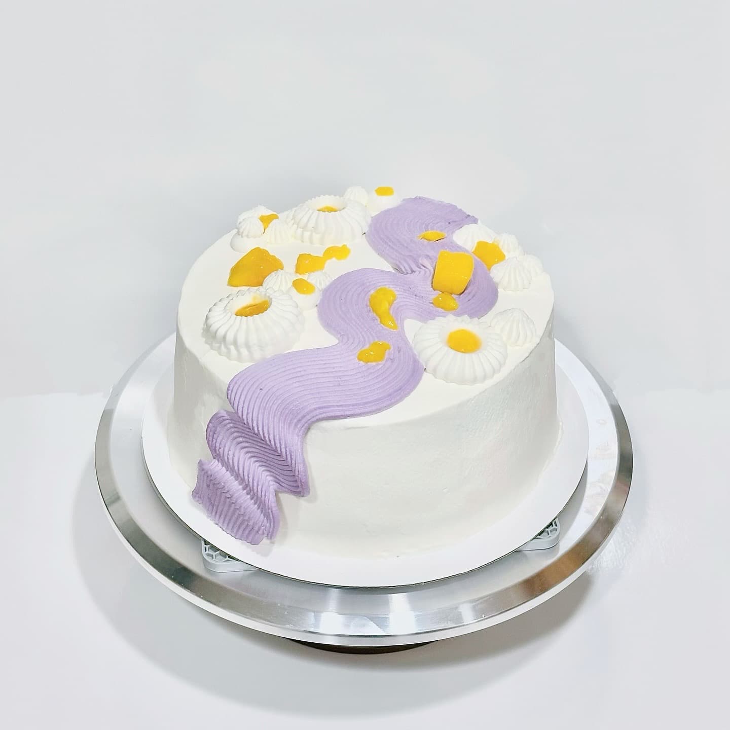 Round cake with lavender swirl and mango