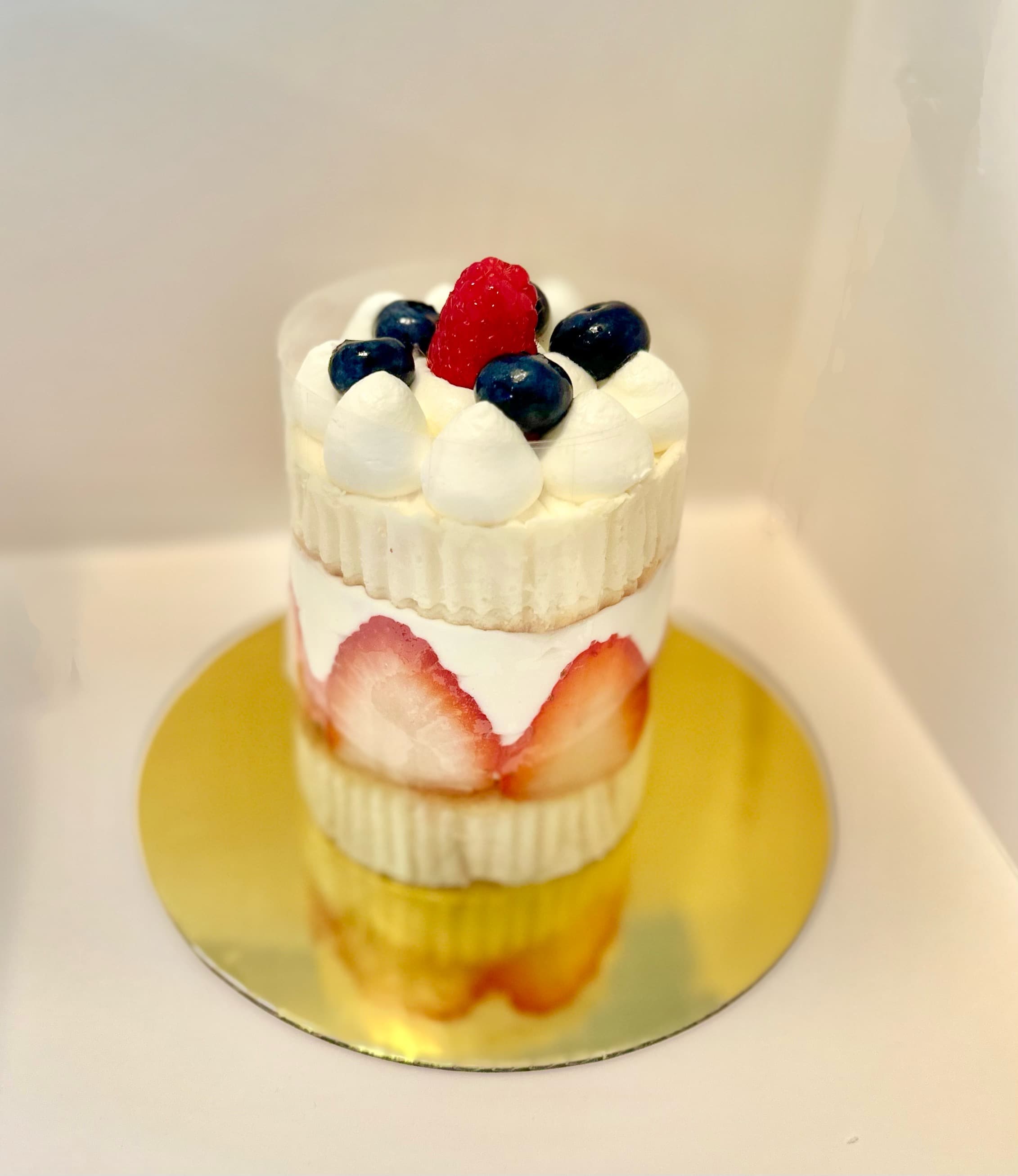 Layered berry shortcake with strawberries and blueberries in clear container