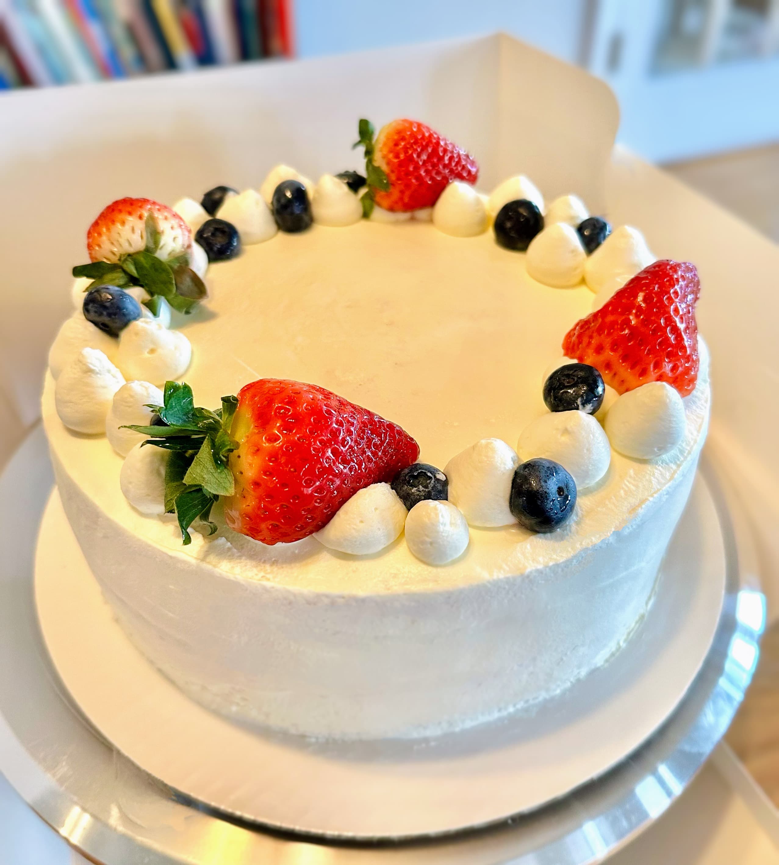 Strawberry blueberry cake with piped border