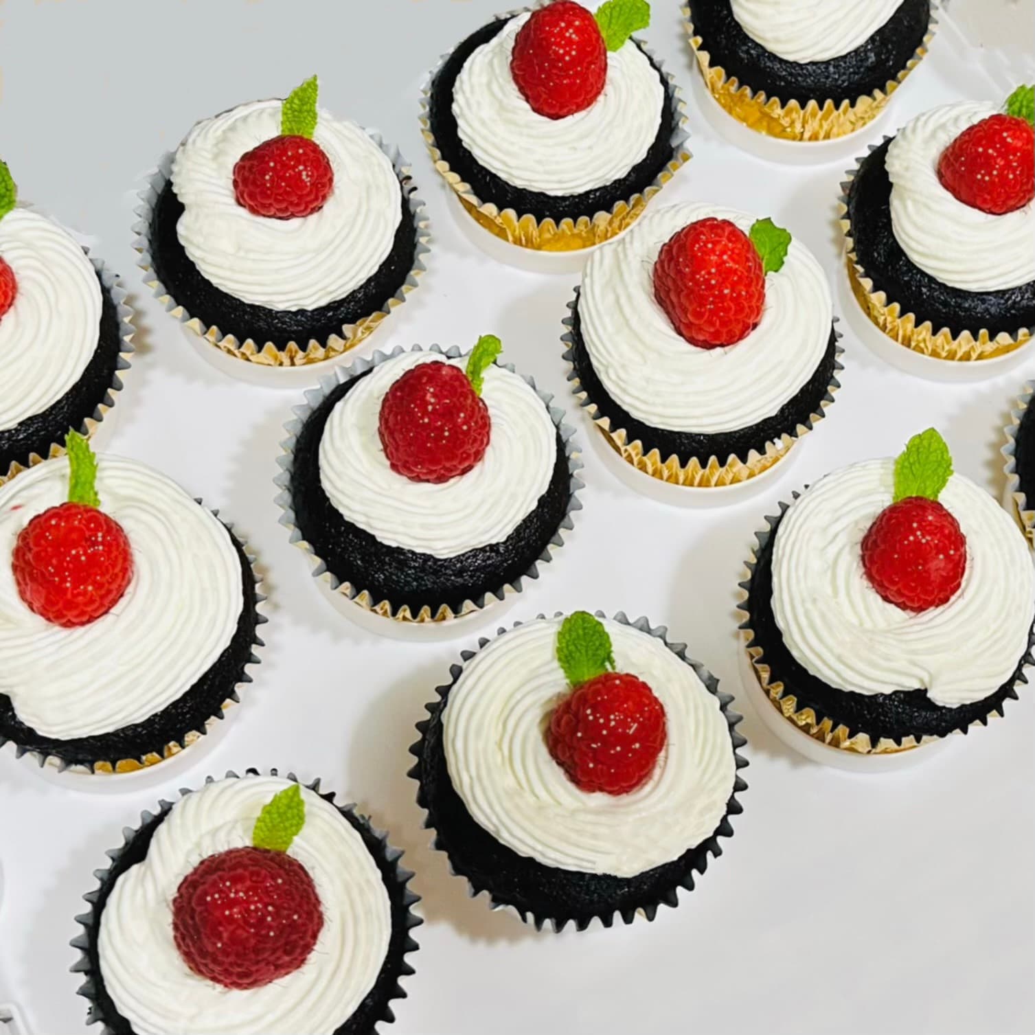 Chocolate cupcakes with raspberry and mint